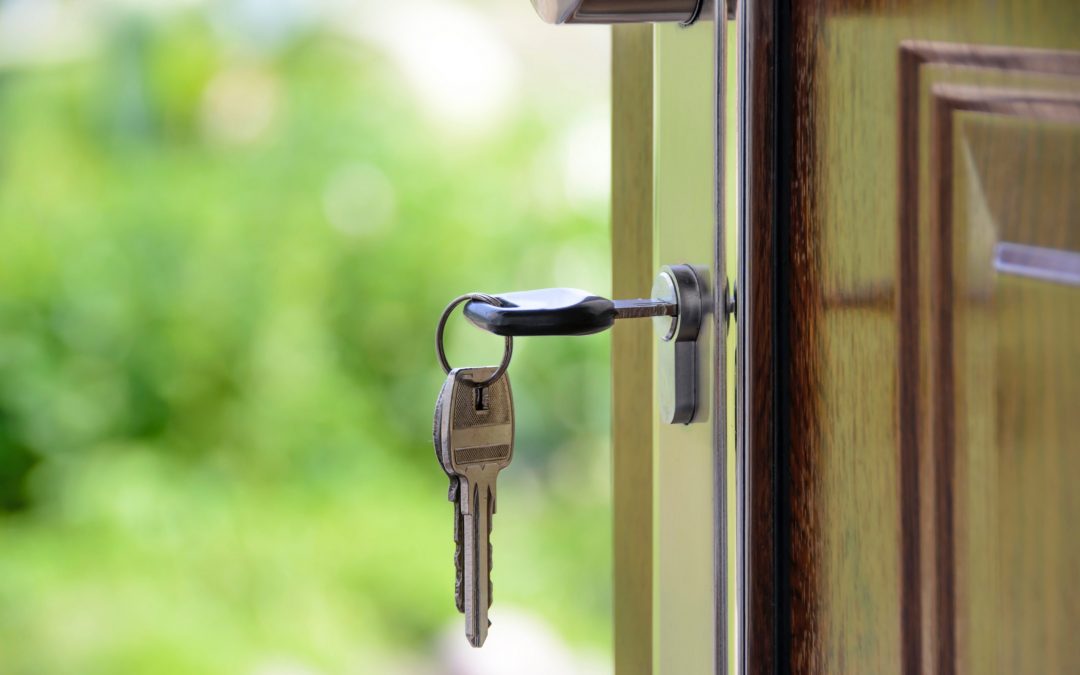 A key to a home is in the lock of a front door.